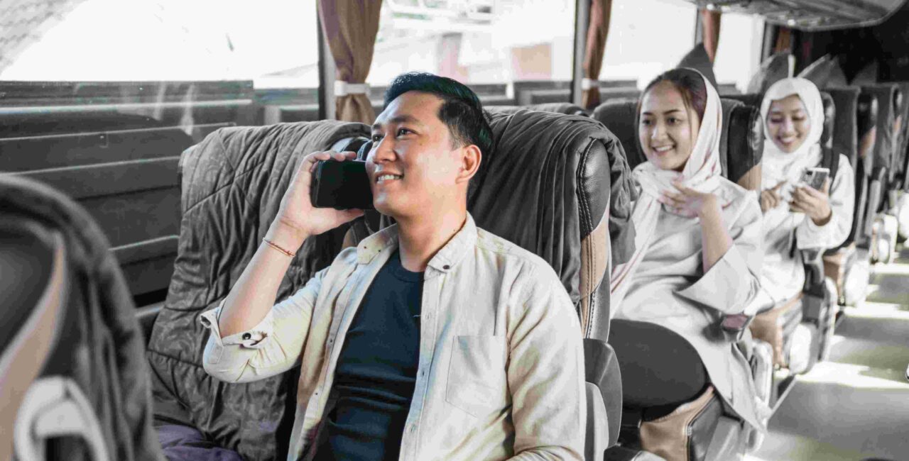 Happy man sitting enjoying his trip using a bus