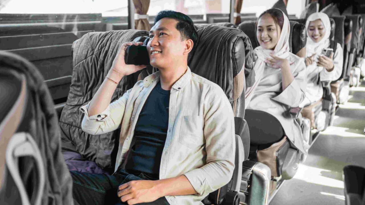 Happy man sitting enjoying his trip using a bus